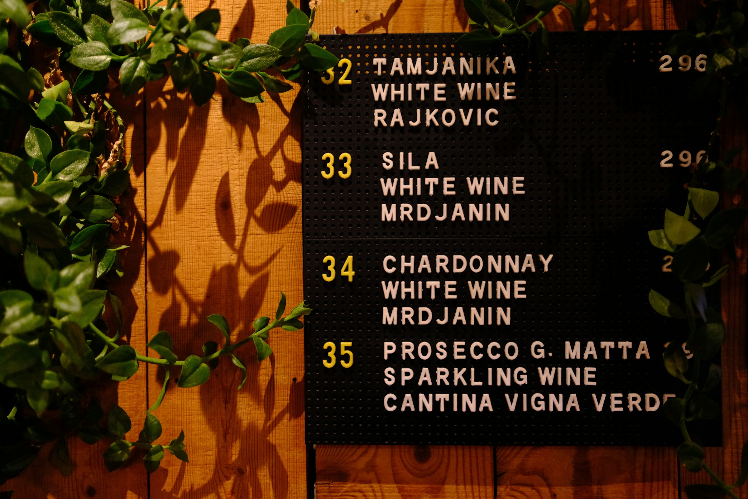A chalkboard wine list between vines