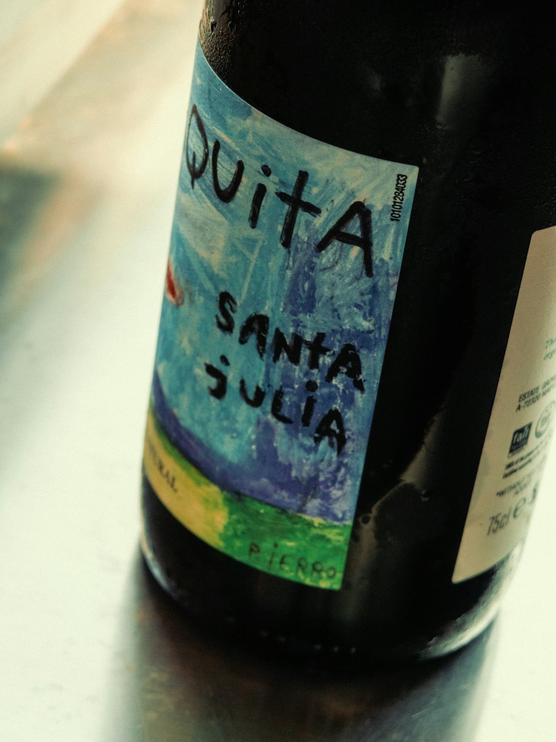 A wine bottle with a colourful hand-drawn label